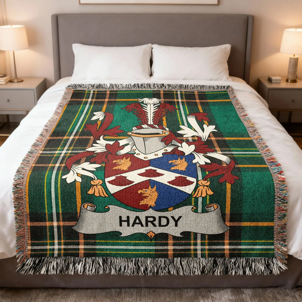 Green plaid blanket featuring the Hardy family crest on a bed.