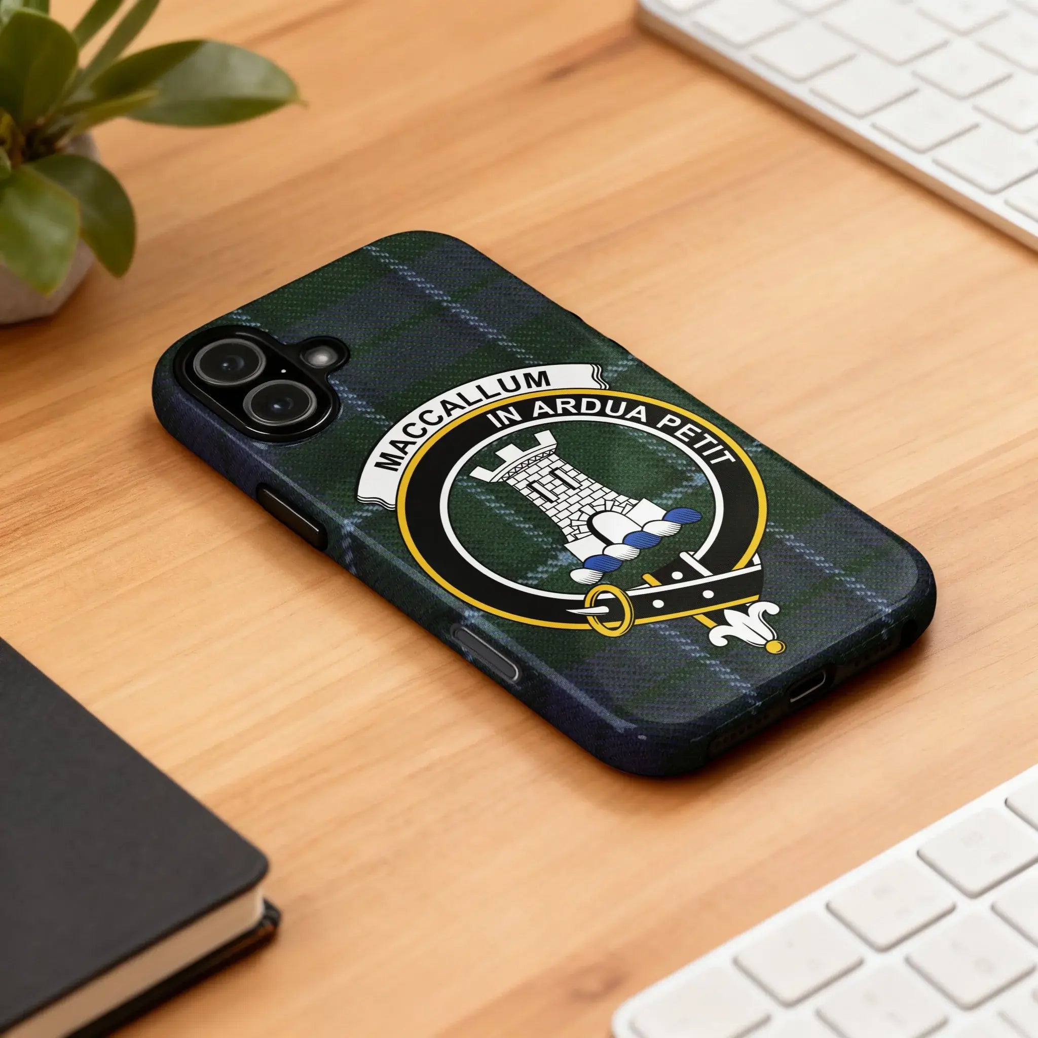 MacCallum tartan crest case on iPhone — edge-to-edge blue and green plaid print