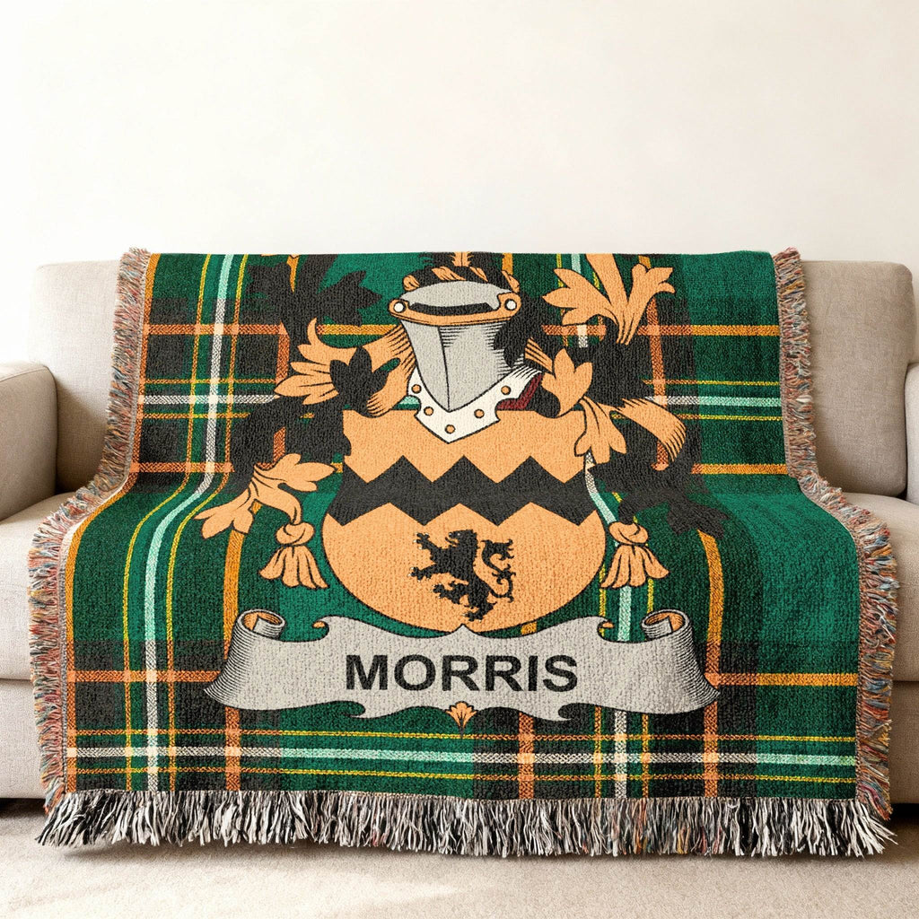 Woven blanket with Morris family crest on green plaid background.
