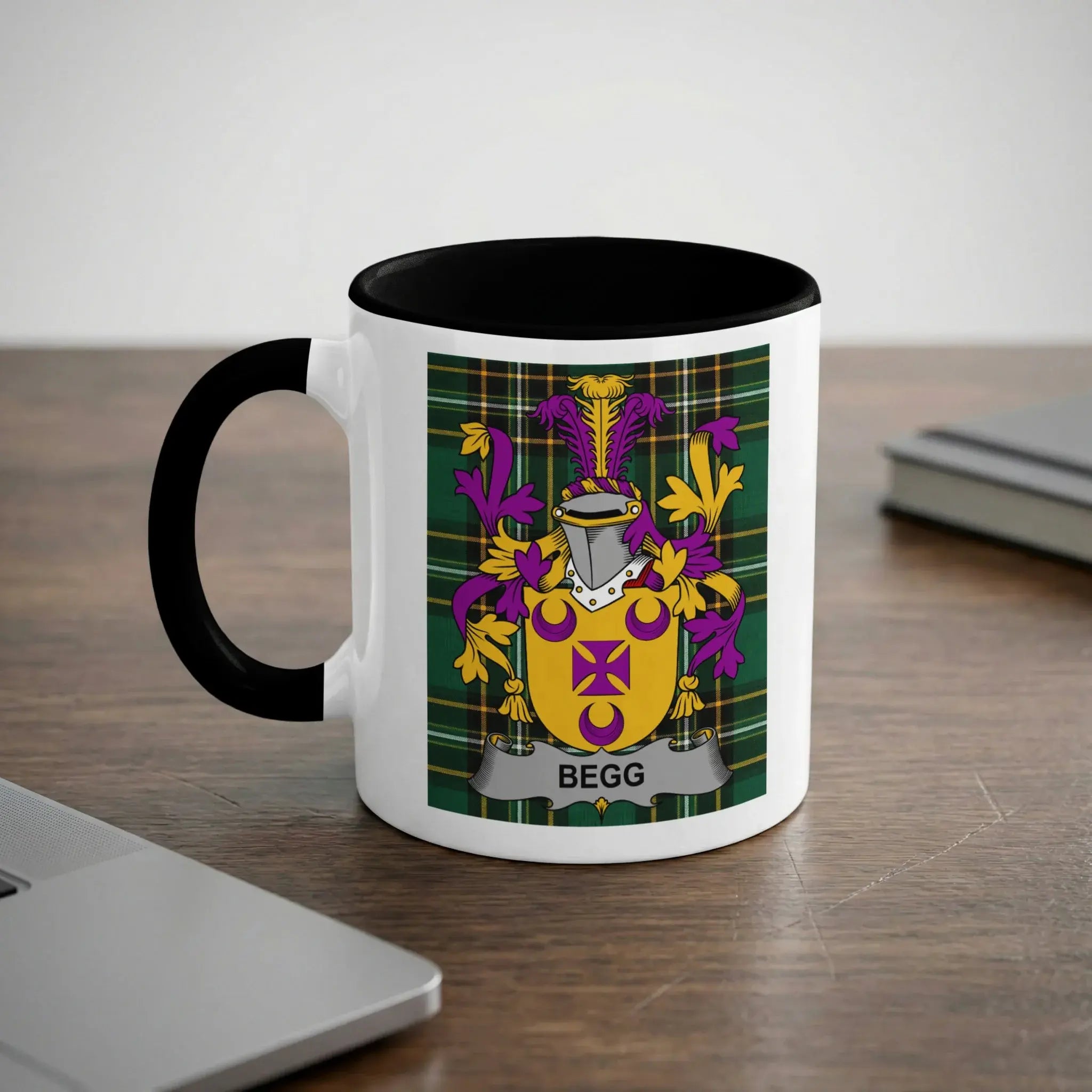 White mug with black rim featuring a coat of arms with the name "BEGG".
