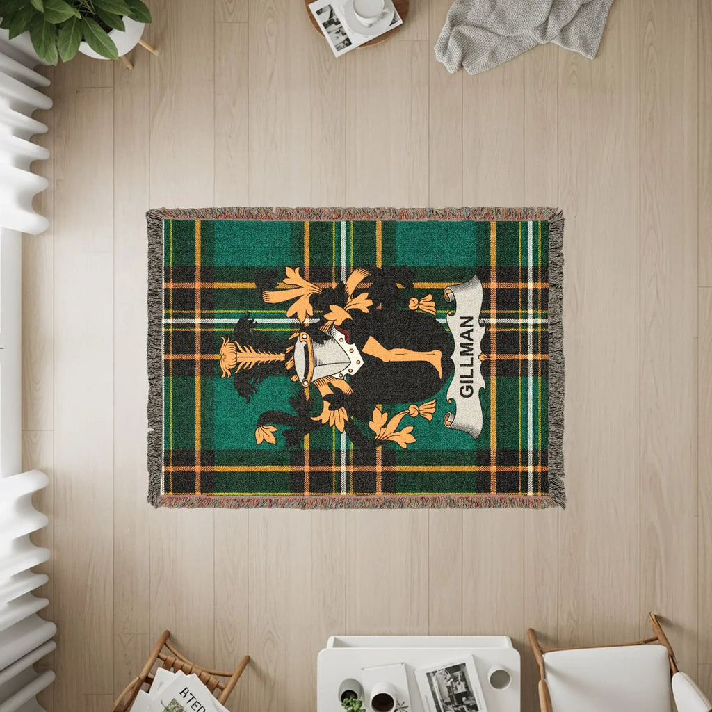 Green and black plaid throw blanket with the Gilman family crest.