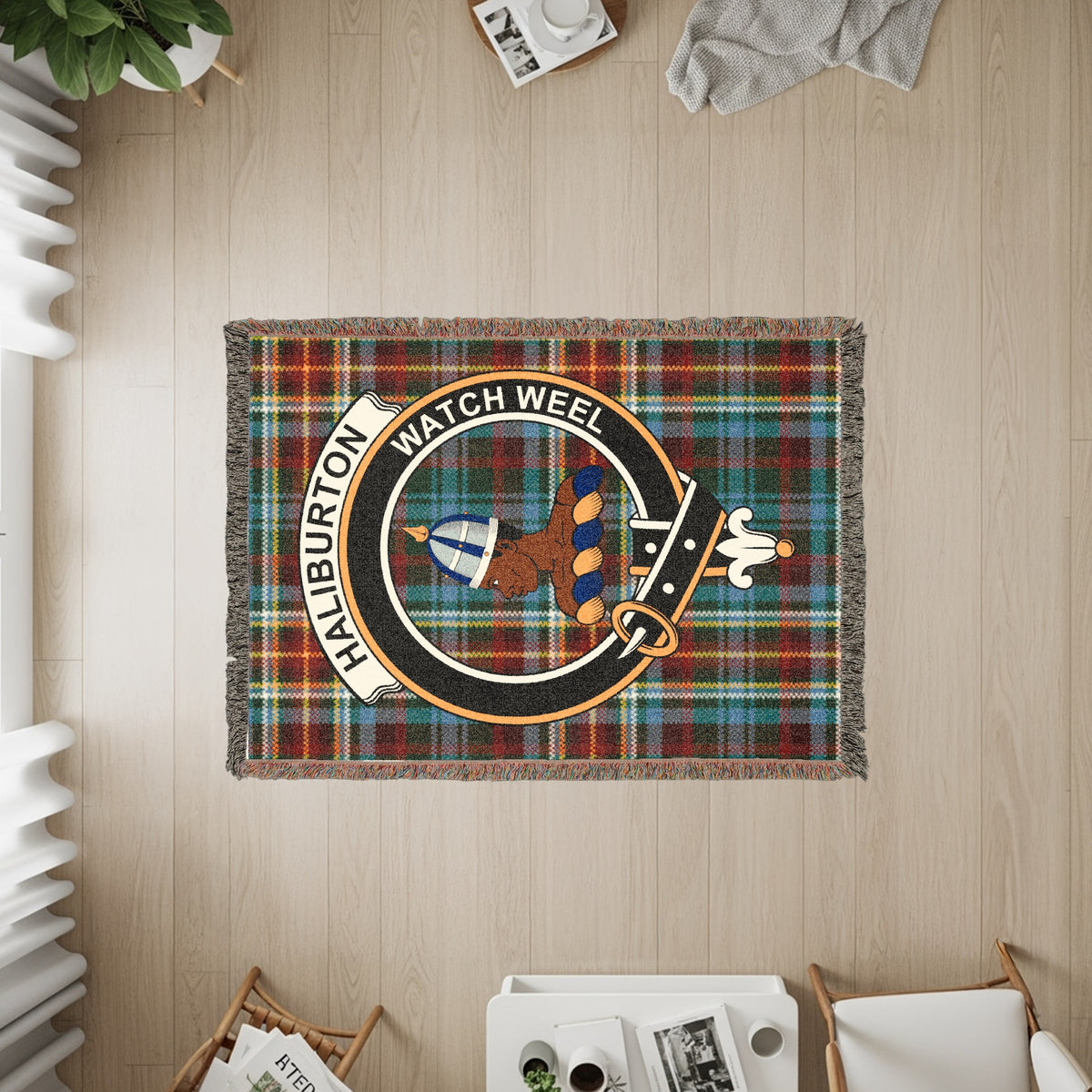 Haliburton woven blanket displayed on a wall, featuring the crest badge and tartan background