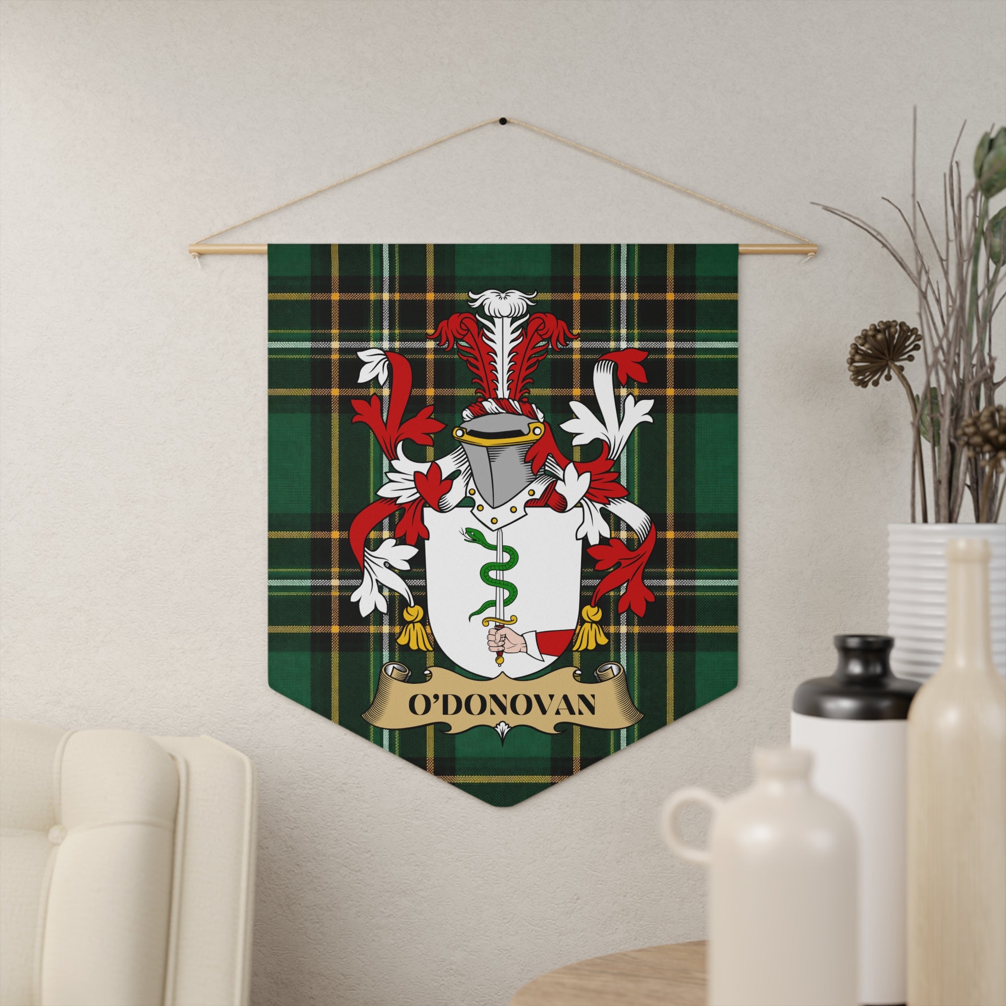 O'DONOVAN crest hanging on green tartan background with white and red accents.