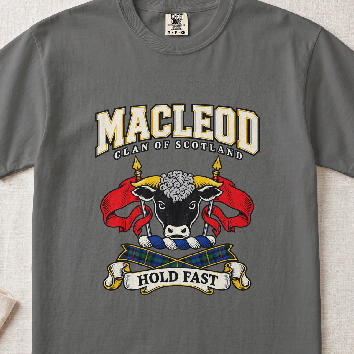 MacLeod graphic T-shirt in Pepper gray, front flat lay showing varsity lettering and black bull head with gold horns and white forehead curls.