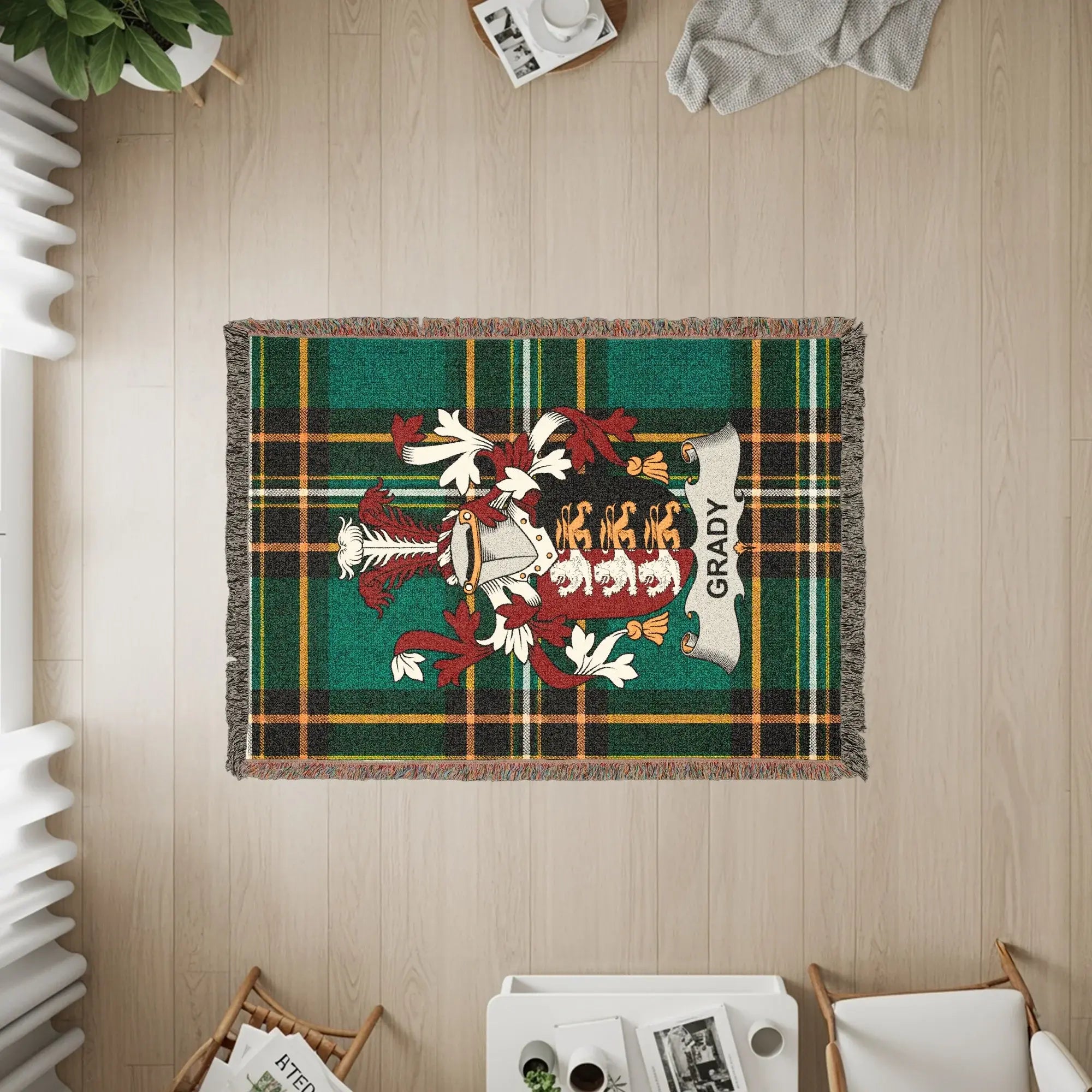 Green plaid throw blanket with Grady crest and fringed edges.