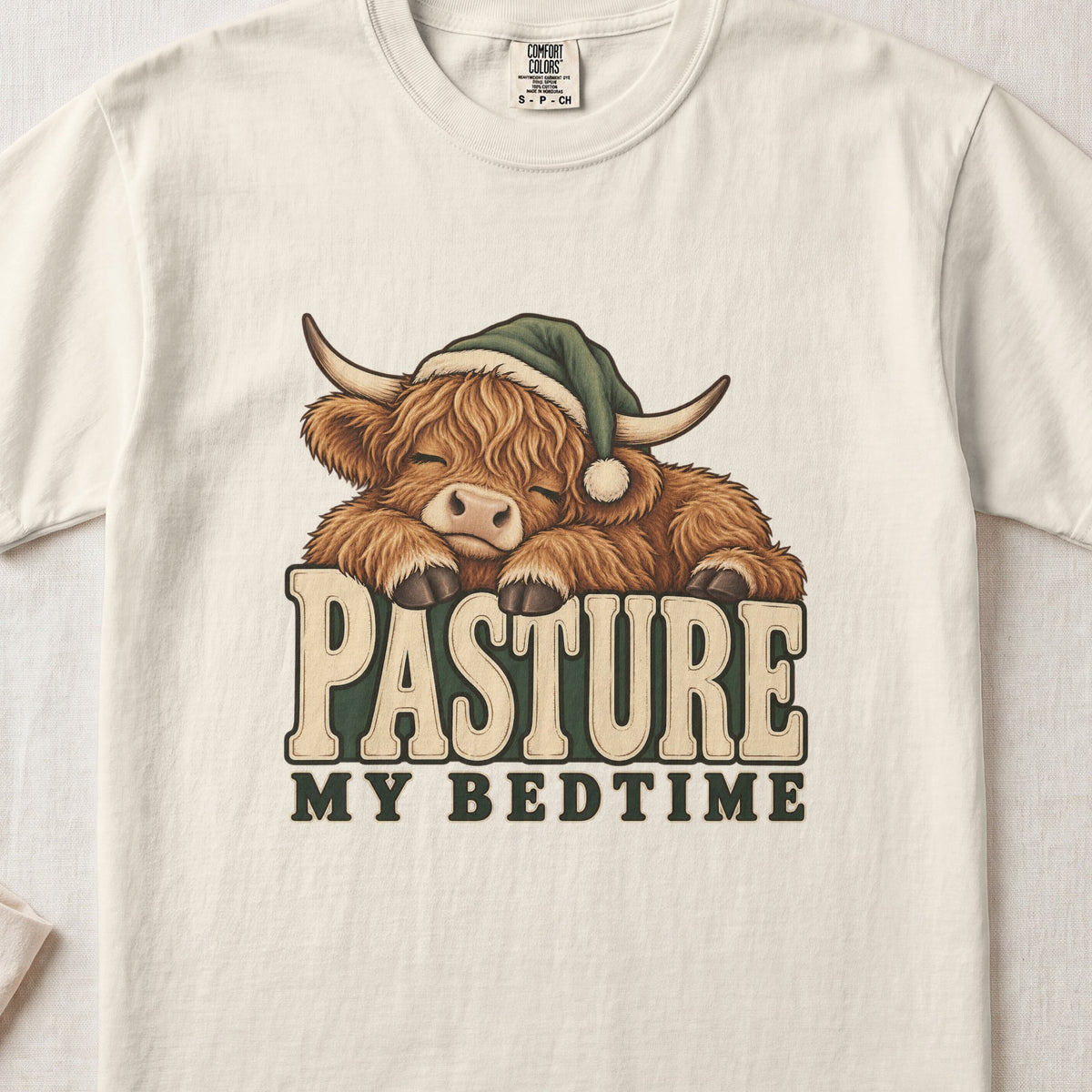 Pasture My Bedtime Highland cow design on an Ivory Comfort Colors 1717 T-shirt, flat lay