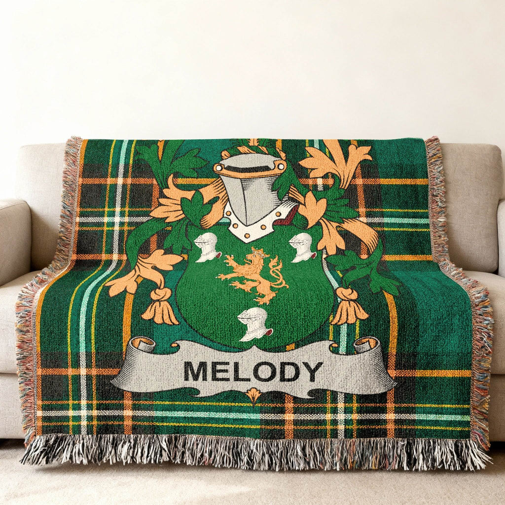 Green plaid blanket featuring a crest with the name "Melody."
