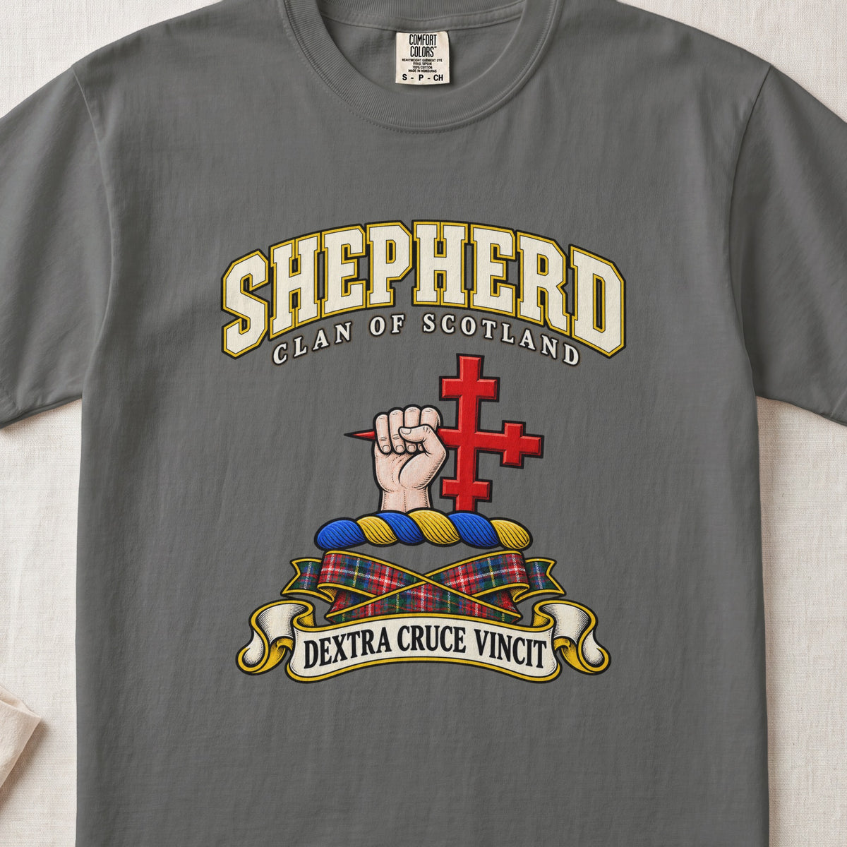 Shepherd Scottish clan T-shirt in Pepper, front view with a hand holding a red cross and motto banner.
