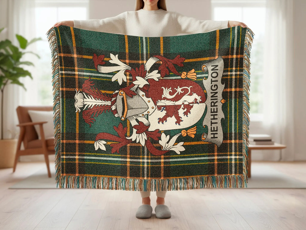 Plaid throw blanket with Hetherington family crest held by person.