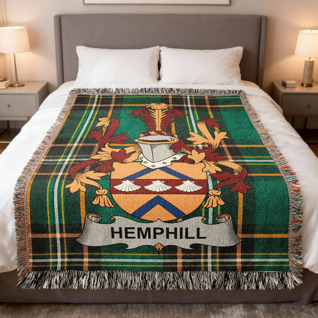 Hemphill family crest on a green plaid throw blanket on a bed.