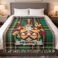 Hemphill family crest on a green plaid throw blanket on a bed.