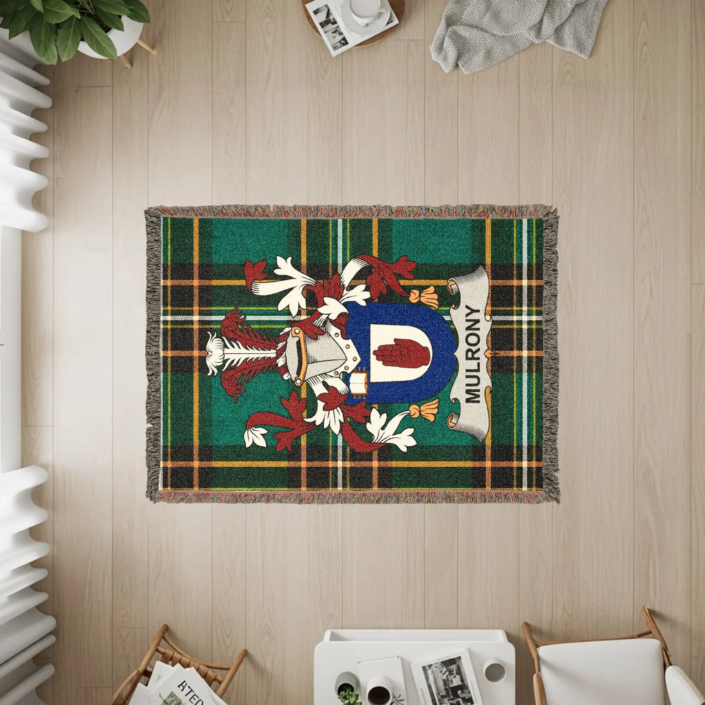 Woven blanket with a green tartan and the Mulroney coat of arms.