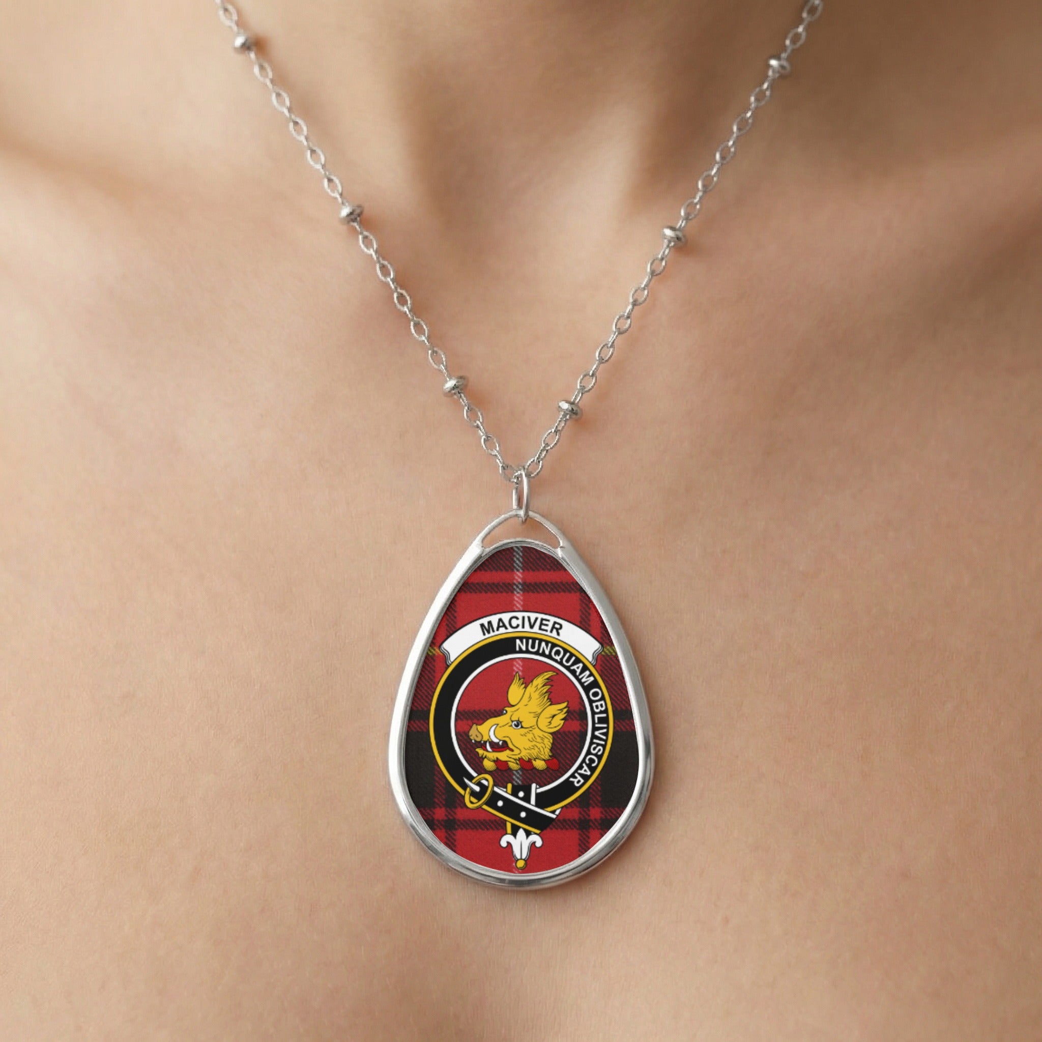 Oval pendant necklace featuring Maciver clan crest on red tartan background.
