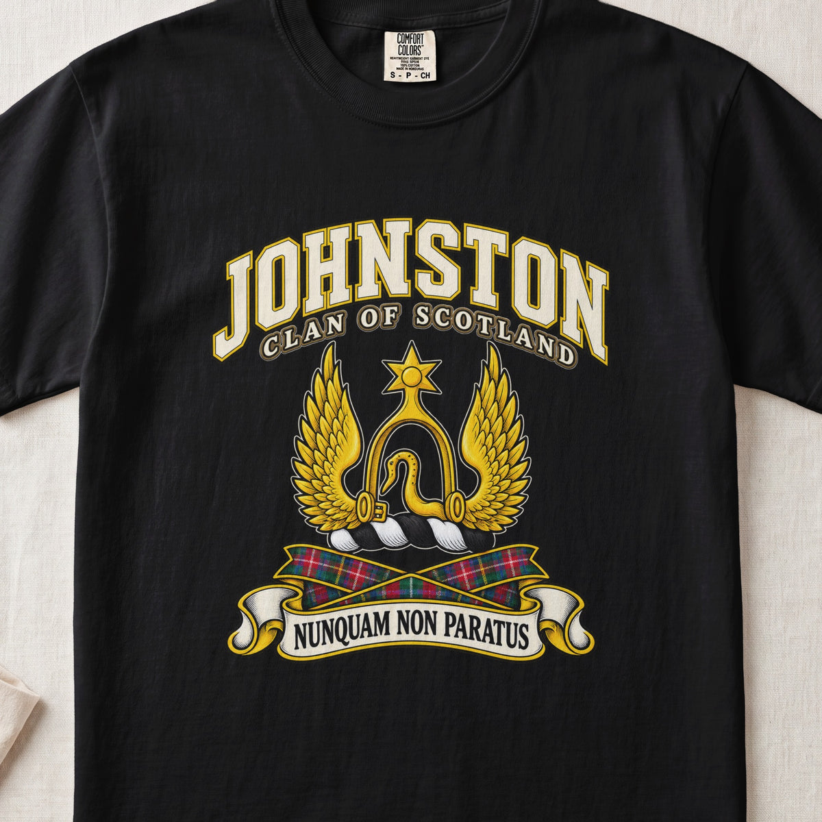 Johnston Scottish clan T-shirt in Black, front view with a golden winged emblem beneath a star and motto banner.