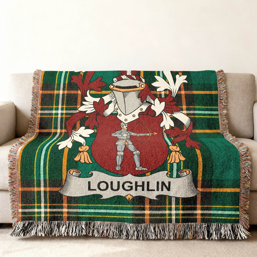 Green tartan throw blanket with a coat of arms featuring a knight and the name LOUGHLIN.