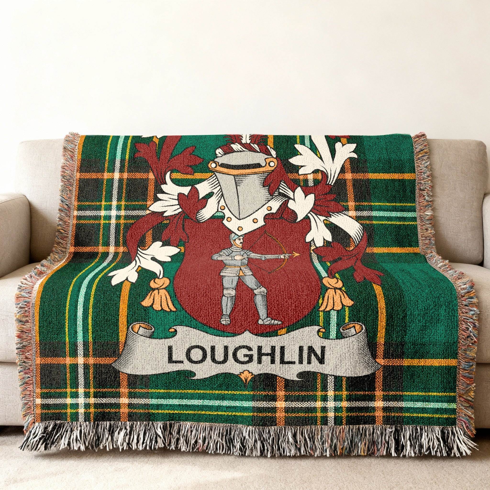 Green tartan throw blanket with a coat of arms featuring a knight and the name LOUGHLIN.