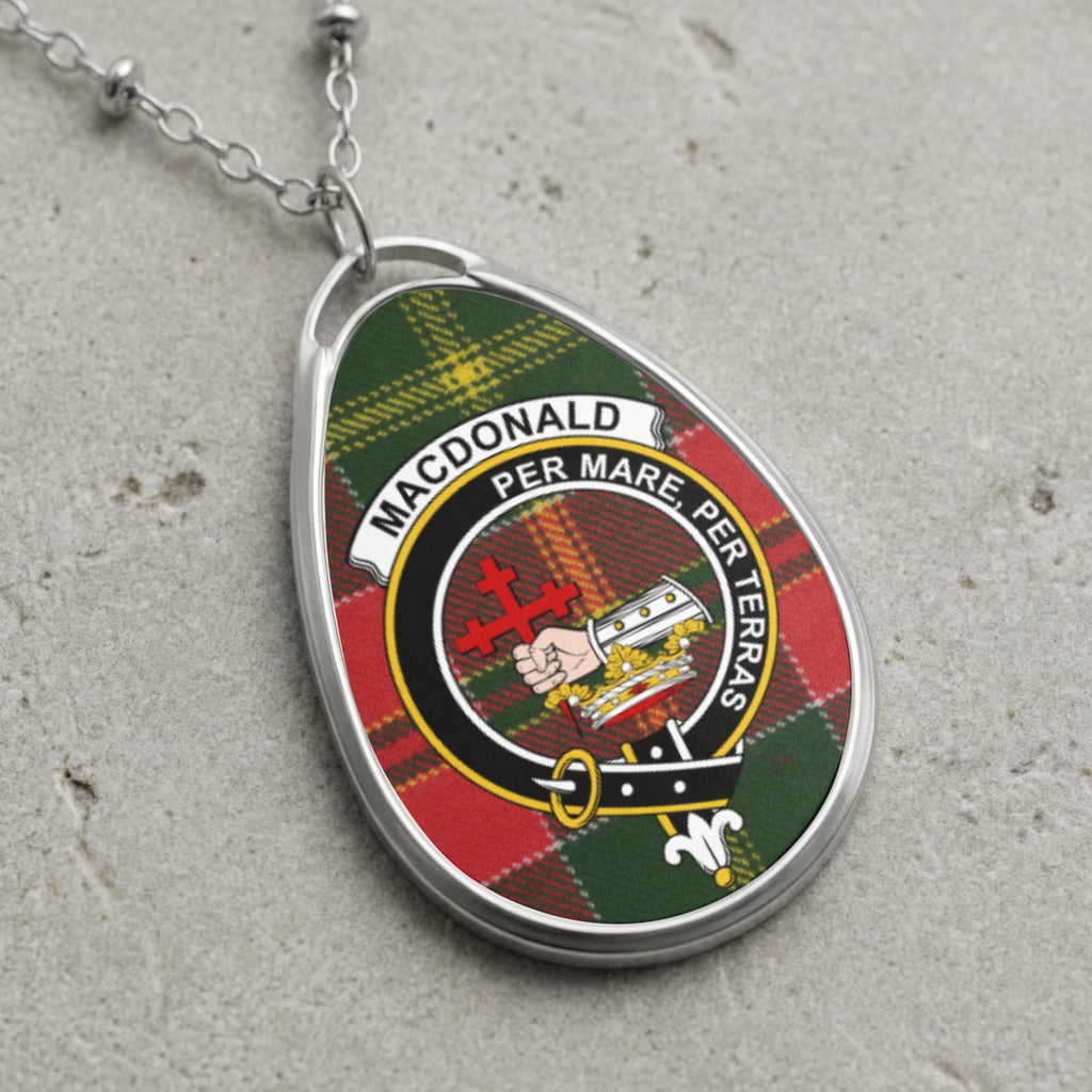 Oval silver pendant with tartan pattern and MacDonald clan crest text.