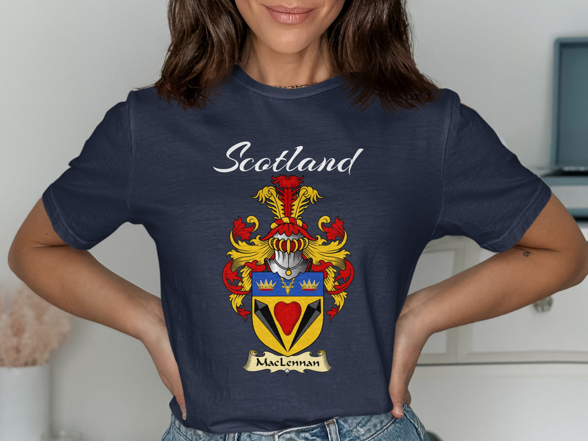 Model wearing a navy MacLennan T-shirt featuring a red heart beneath a blue band with gold crowns