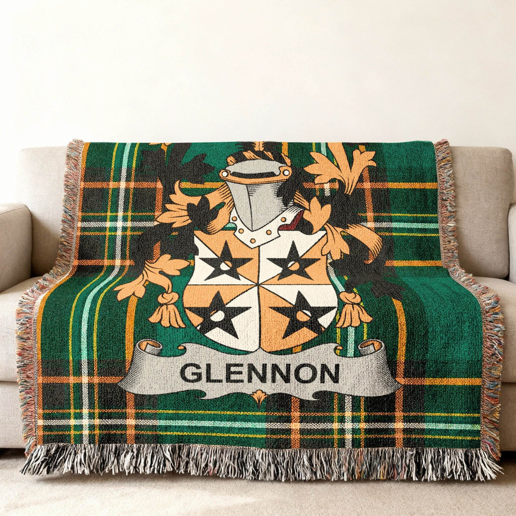 Green tartan blanket with Glennon family crest draped on a sofa.