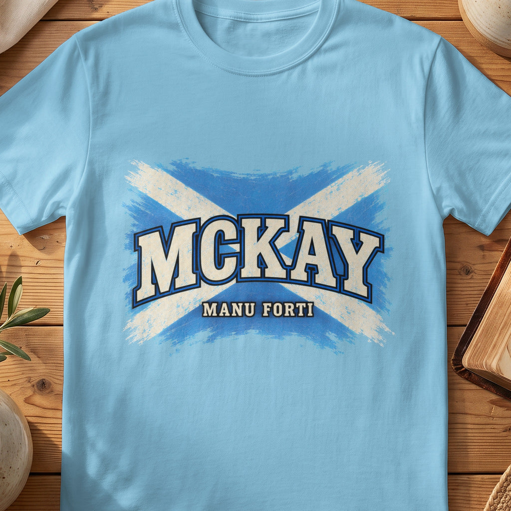 McKay Scottish Saltire T-shirt in Sky, with distressed blue and cream flag and “Manu Forti” lettering.