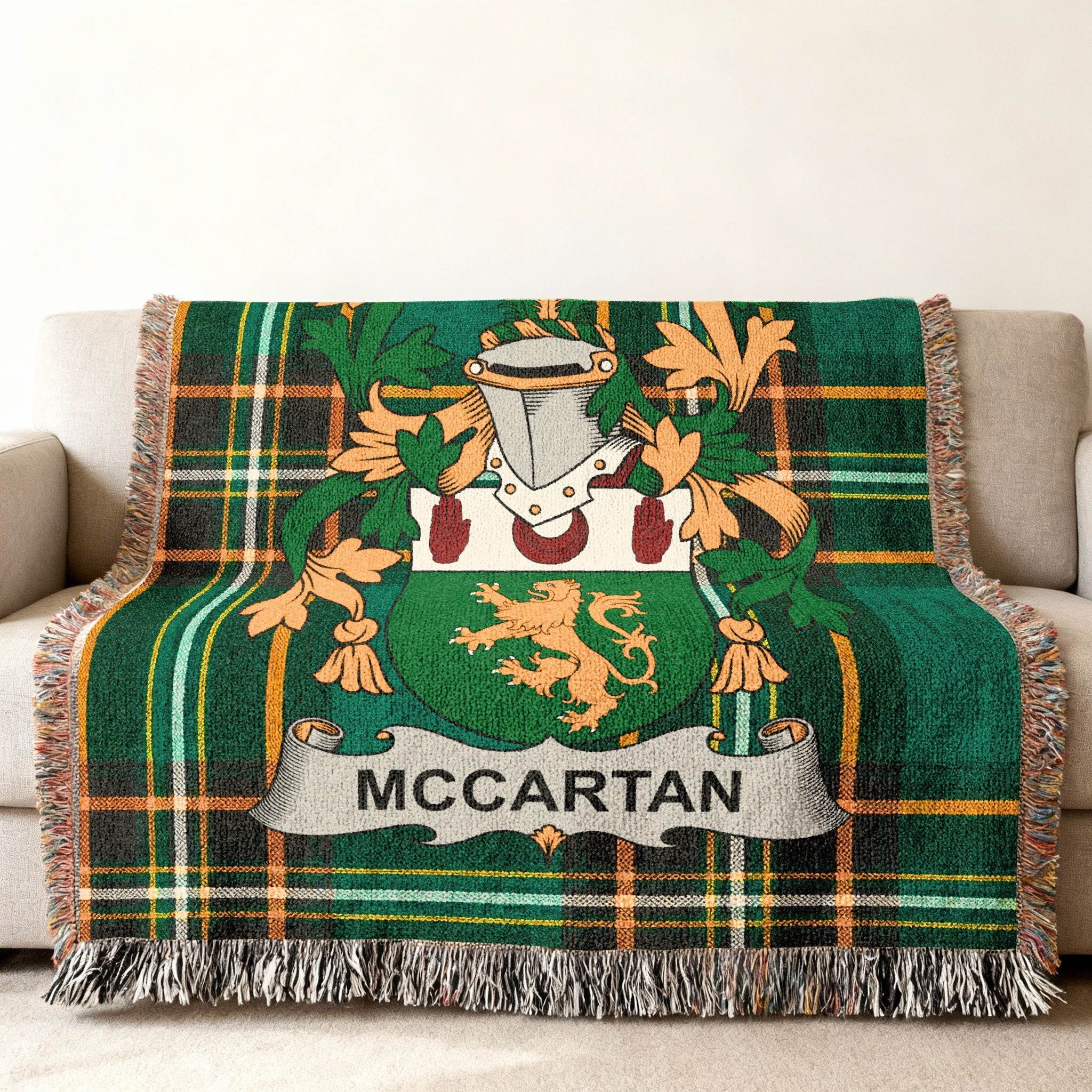 Green tartan throw blanket featuring the McCartan family crest with a lion rampant.