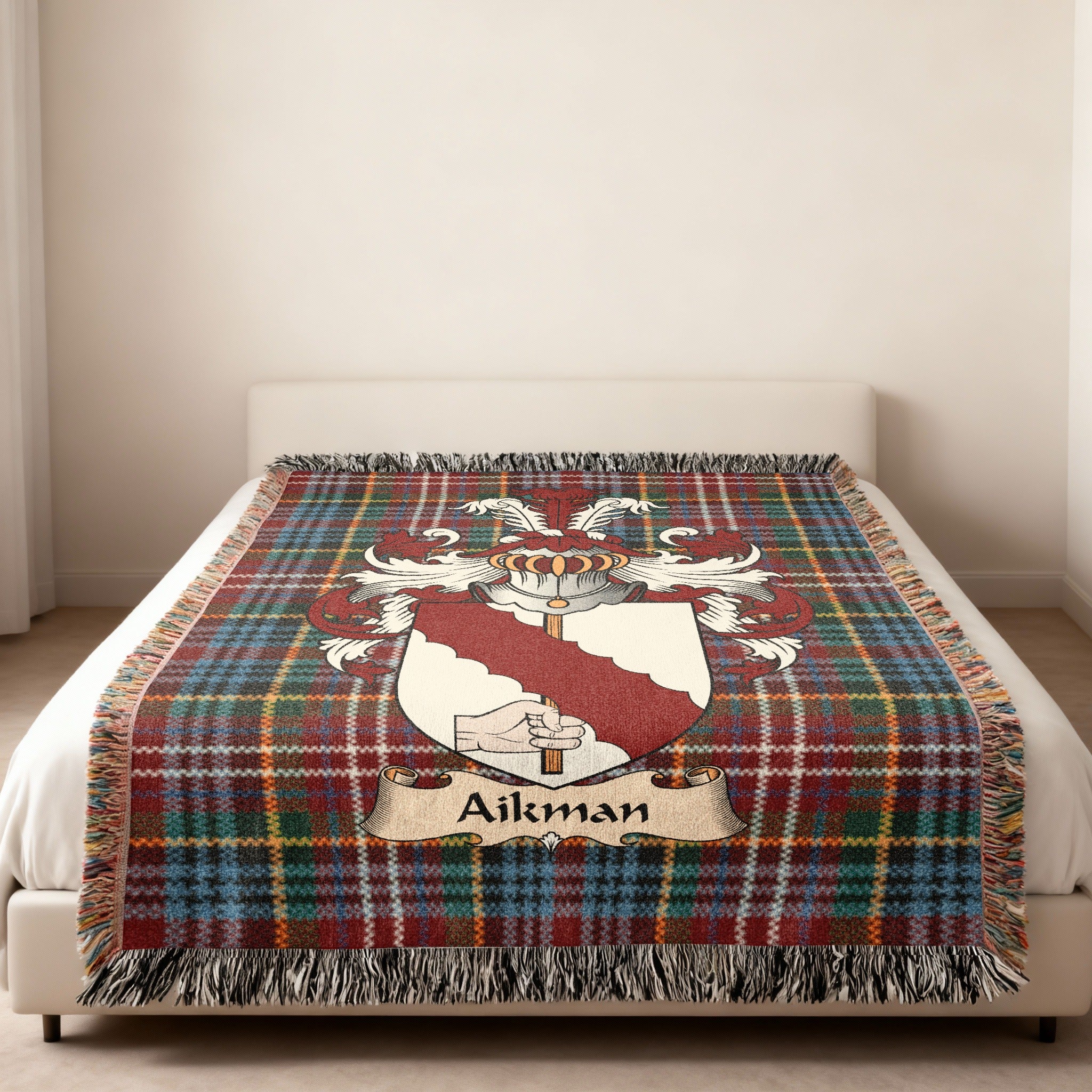 Aikman family crest emblem on a Caledonia tartan woven blanket
