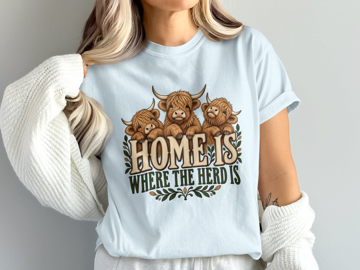 Model wearing the Home Is Where the Herd Is Highland cow Comfort Colors T-shirt in Chambray