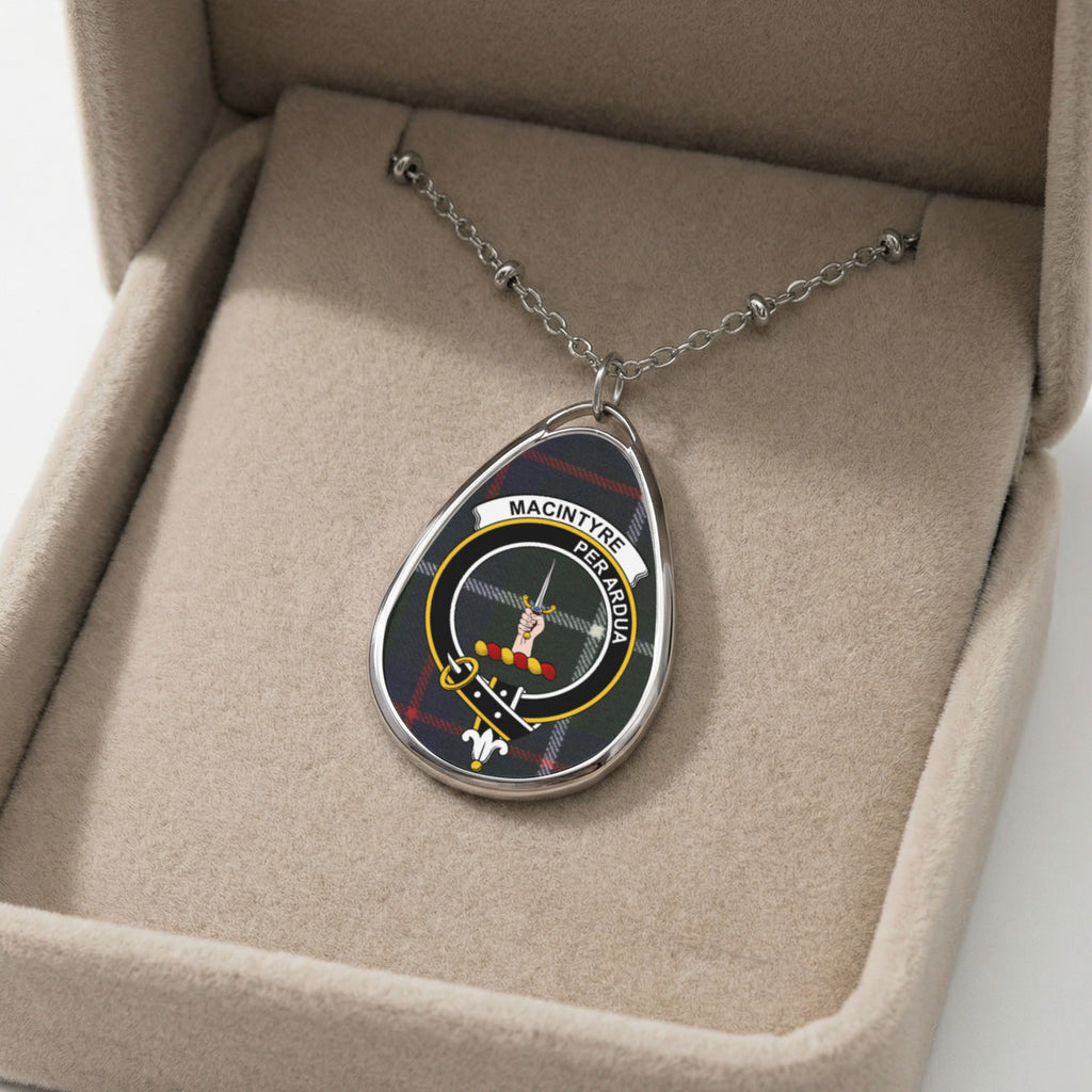 Oval pendant necklace with MacIntyre tartan and crest in a jewelry box.