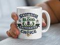 White mug with "Scottish by Blood Caffeinated by Choice" text and thistle design.