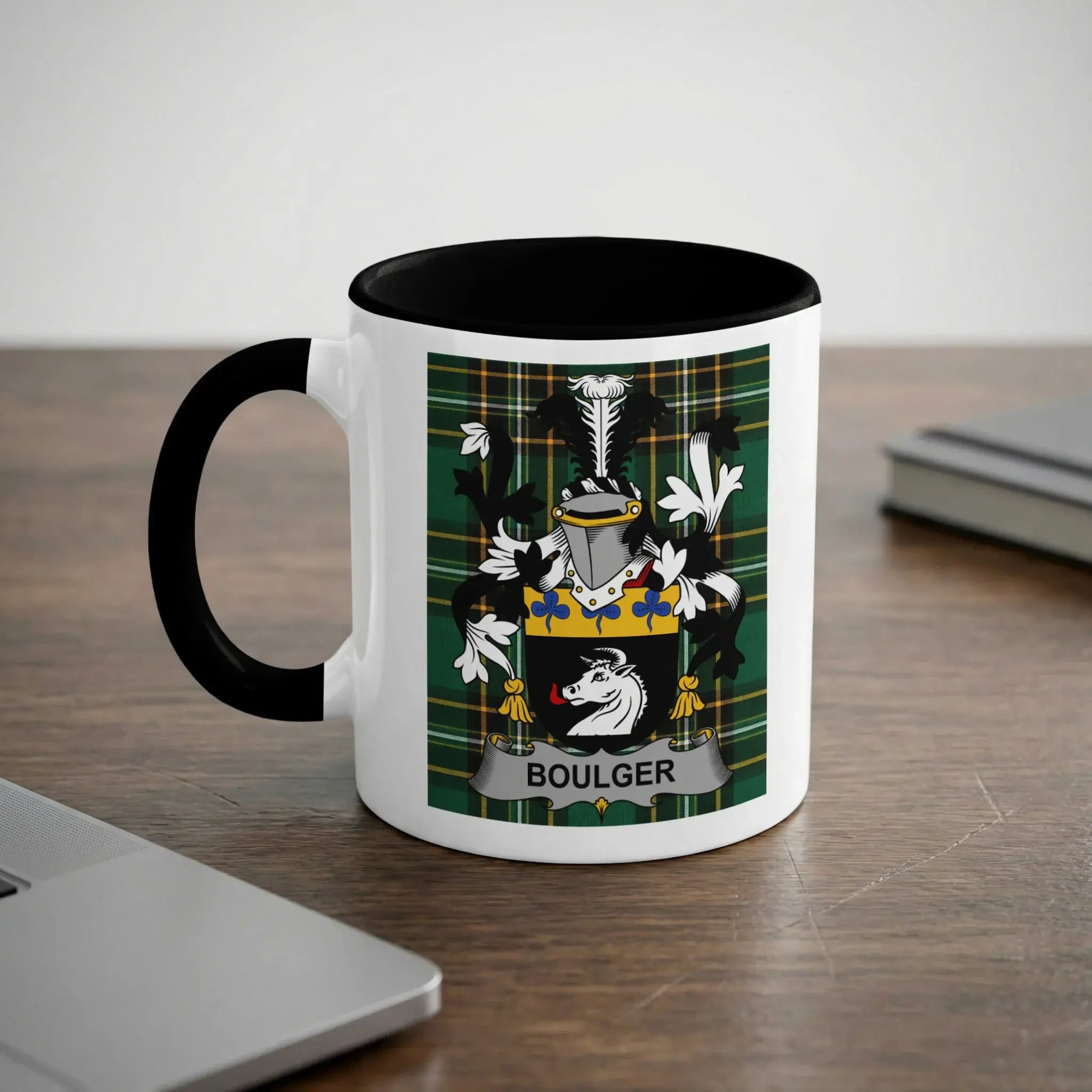 White mug with black handle featuring a green plaid crest with the name BOULGER.