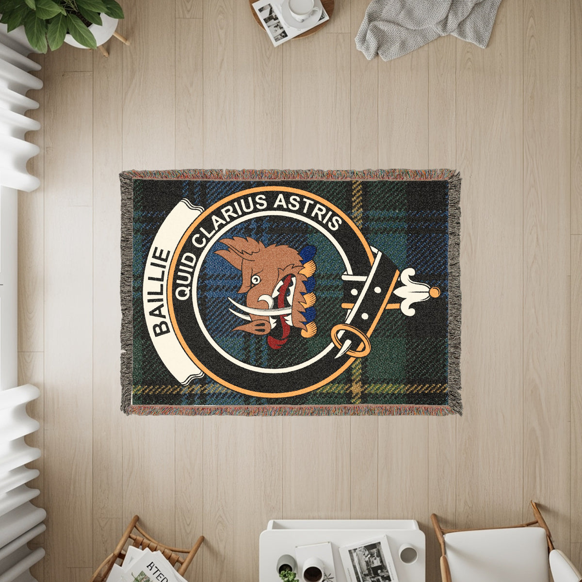 Baillie woven blanket displayed on a wall, featuring the crest badge and tartan background