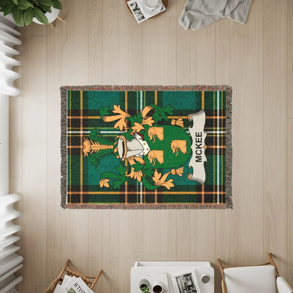 McKee family crest on a green plaid woven throw blanket.