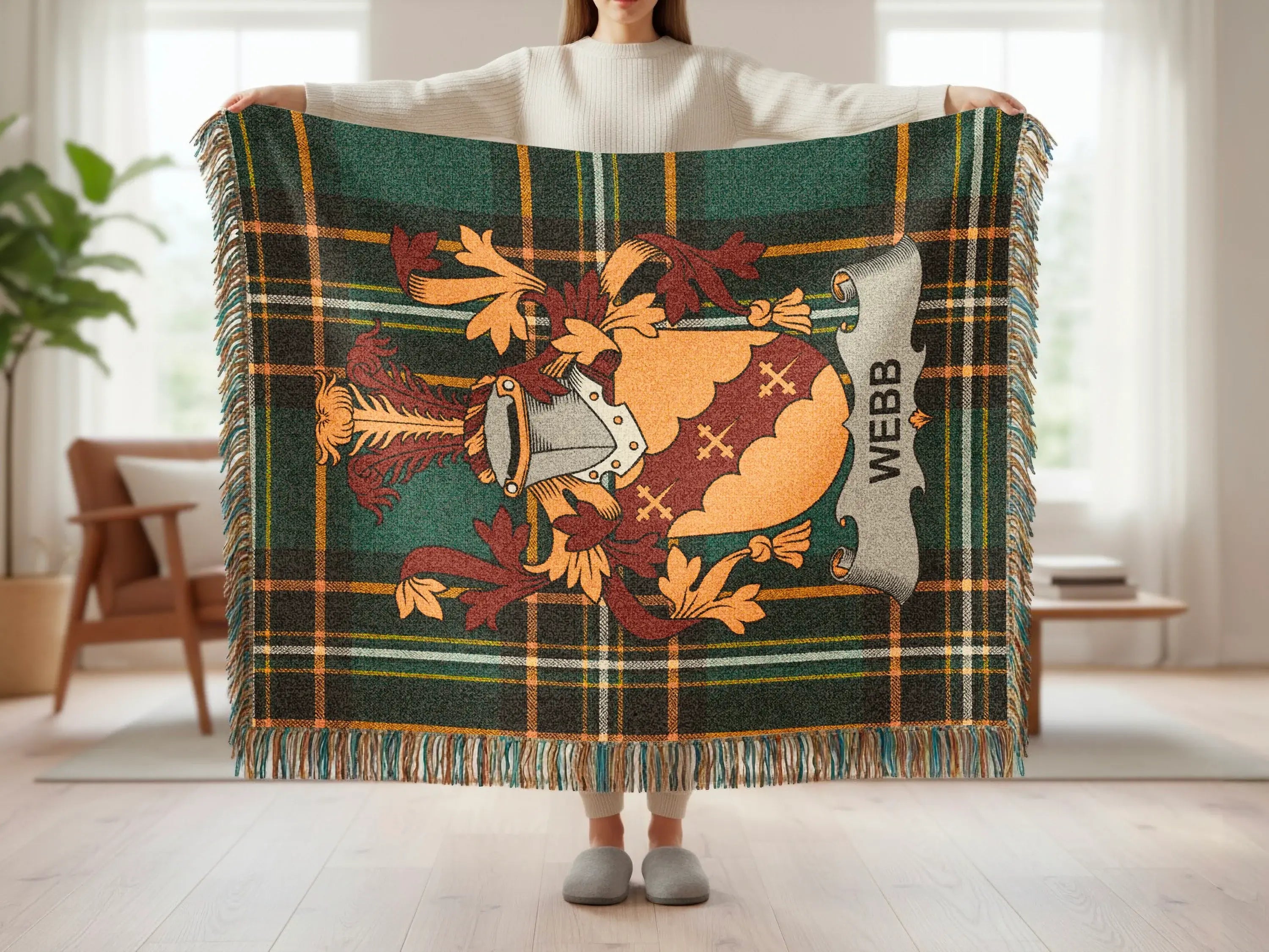 Plaid throw blanket with heraldic crest and "WEBB" text.