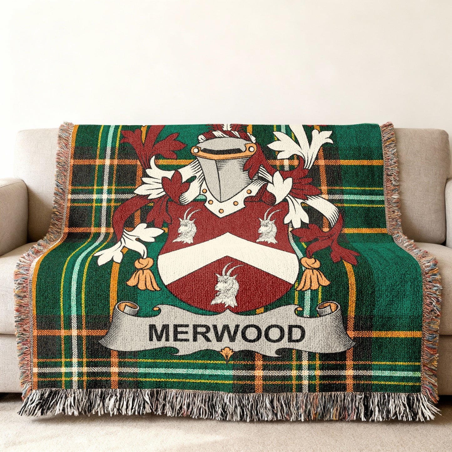 Woven tartan blanket with Merwood family crest on a couch.