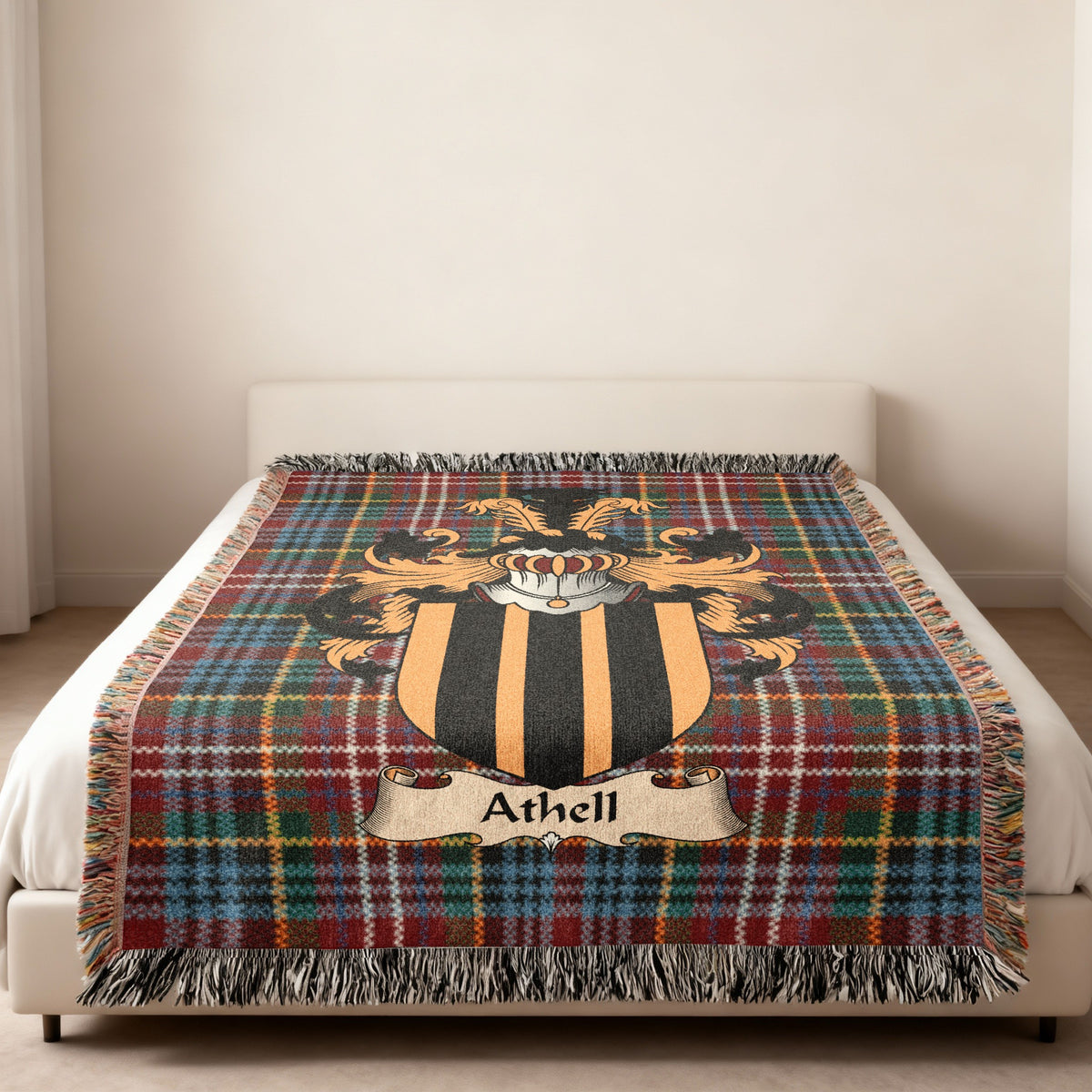 Athell family crest emblem on a Caledonia tartan woven blanket