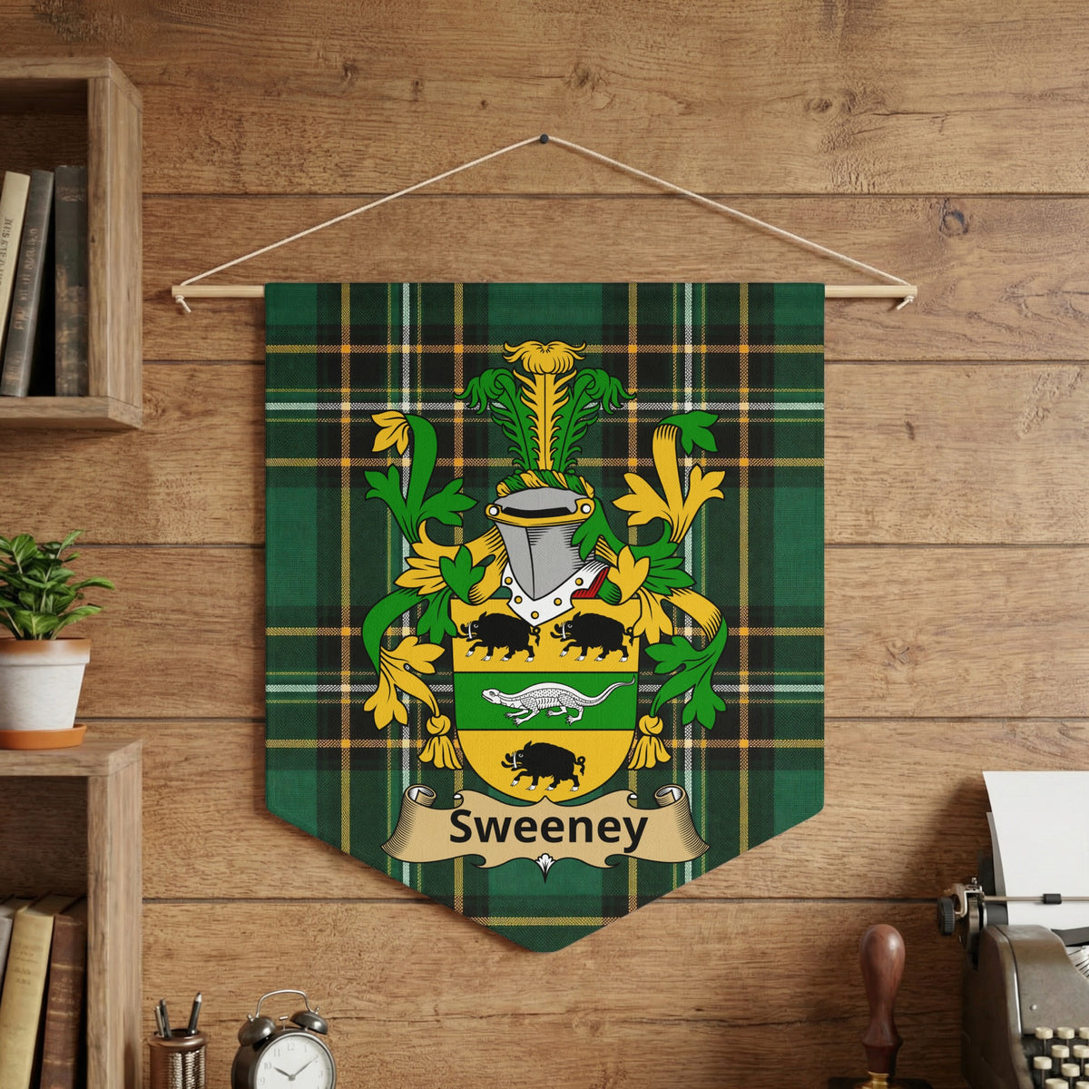 Sweeney family crest banner hanging on a wooden wall, featuring green plaid.