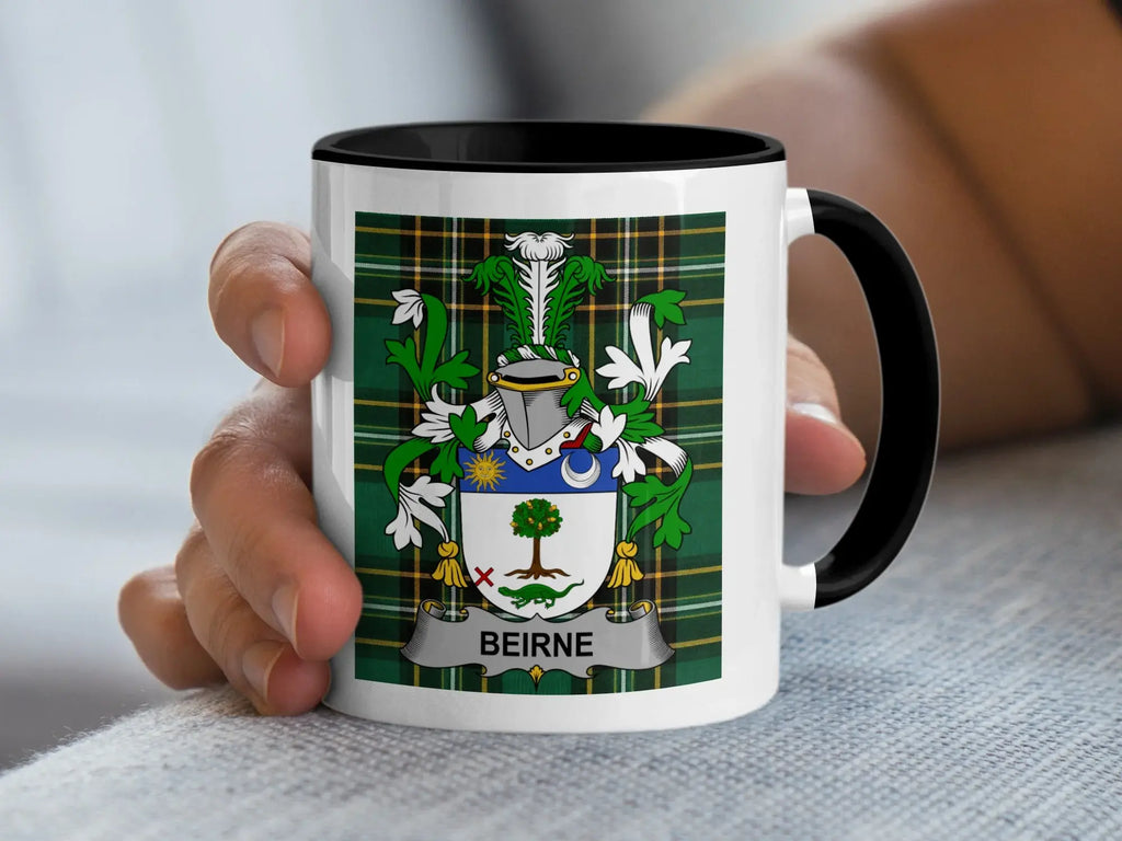 Mug with black handle featuring Beirne family crest on green tartan background.