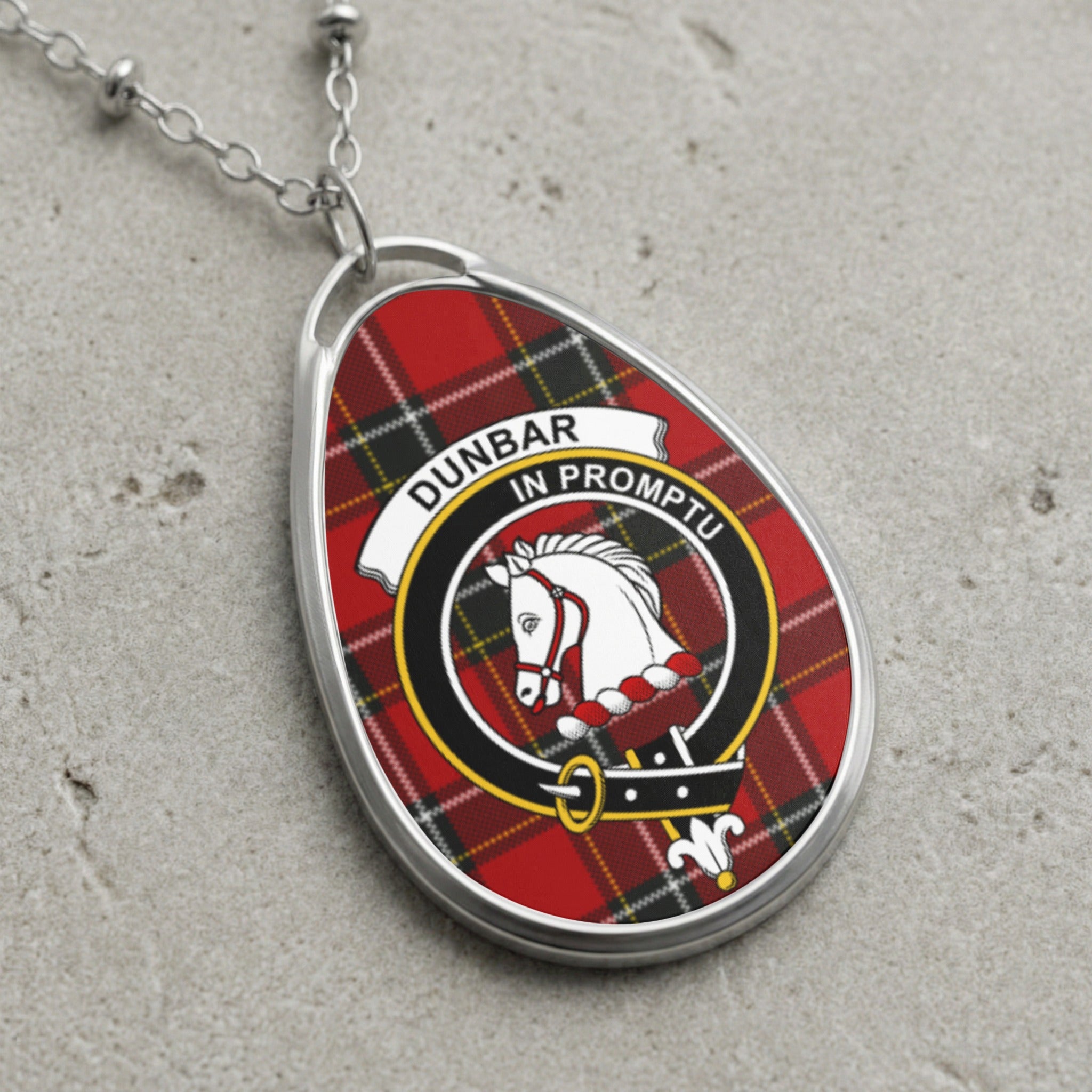 Dunbar clan Scottish tartan necklace with clan crest on tartan background