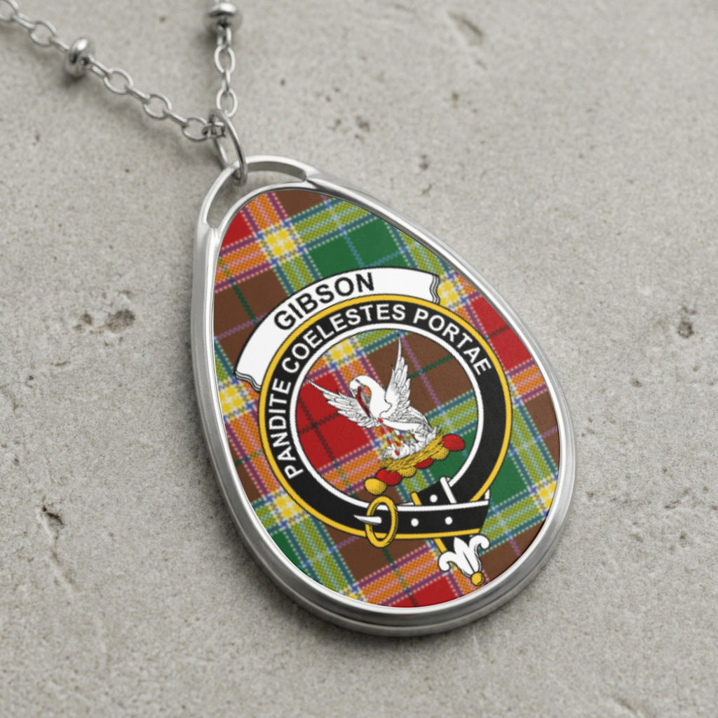 Gibson clan Scottish tartan necklace with clan crest on tartan background