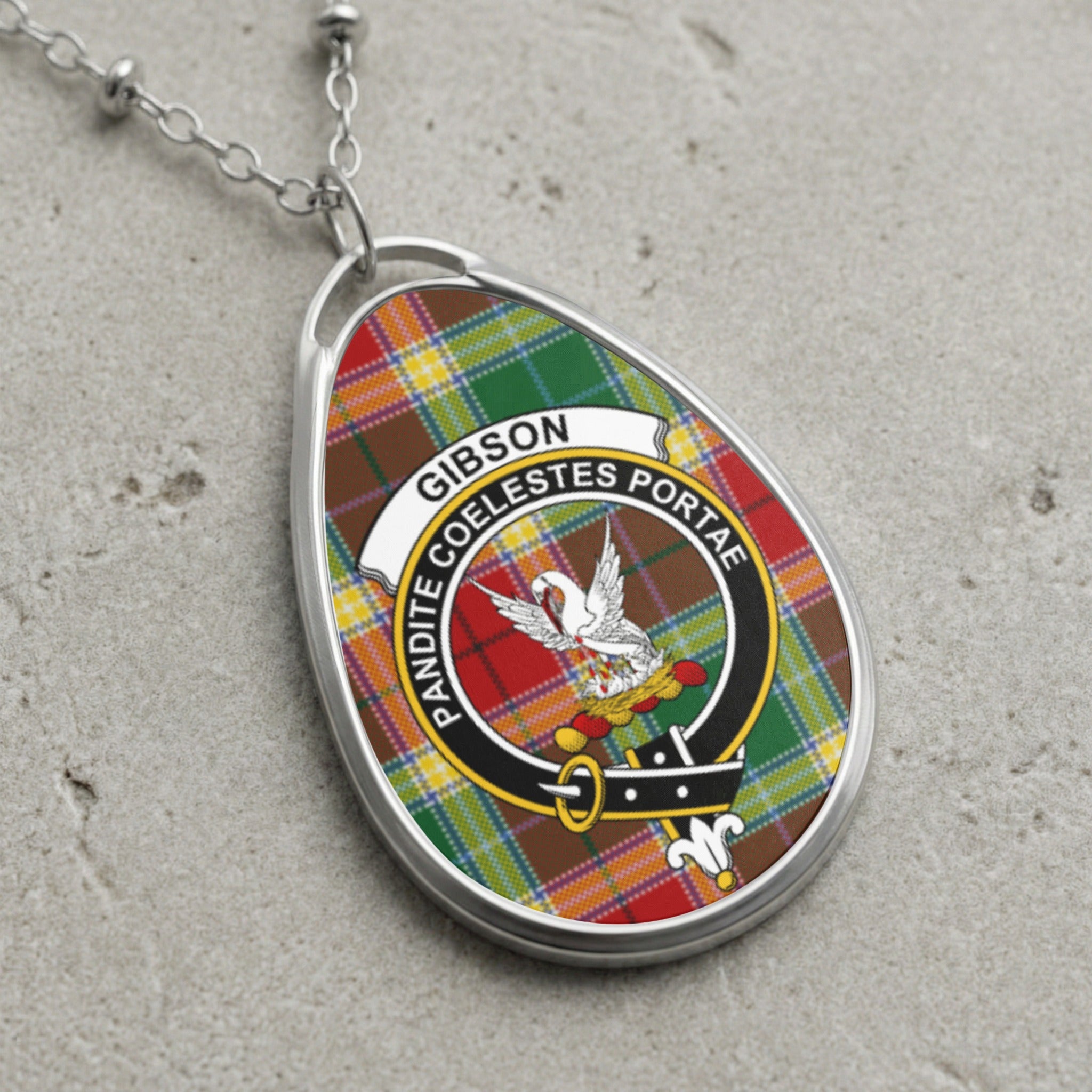 Gibson clan Scottish tartan necklace with clan crest on tartan background