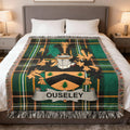 Ouseley tartan blanket featuring a coat of arms and name banner.
