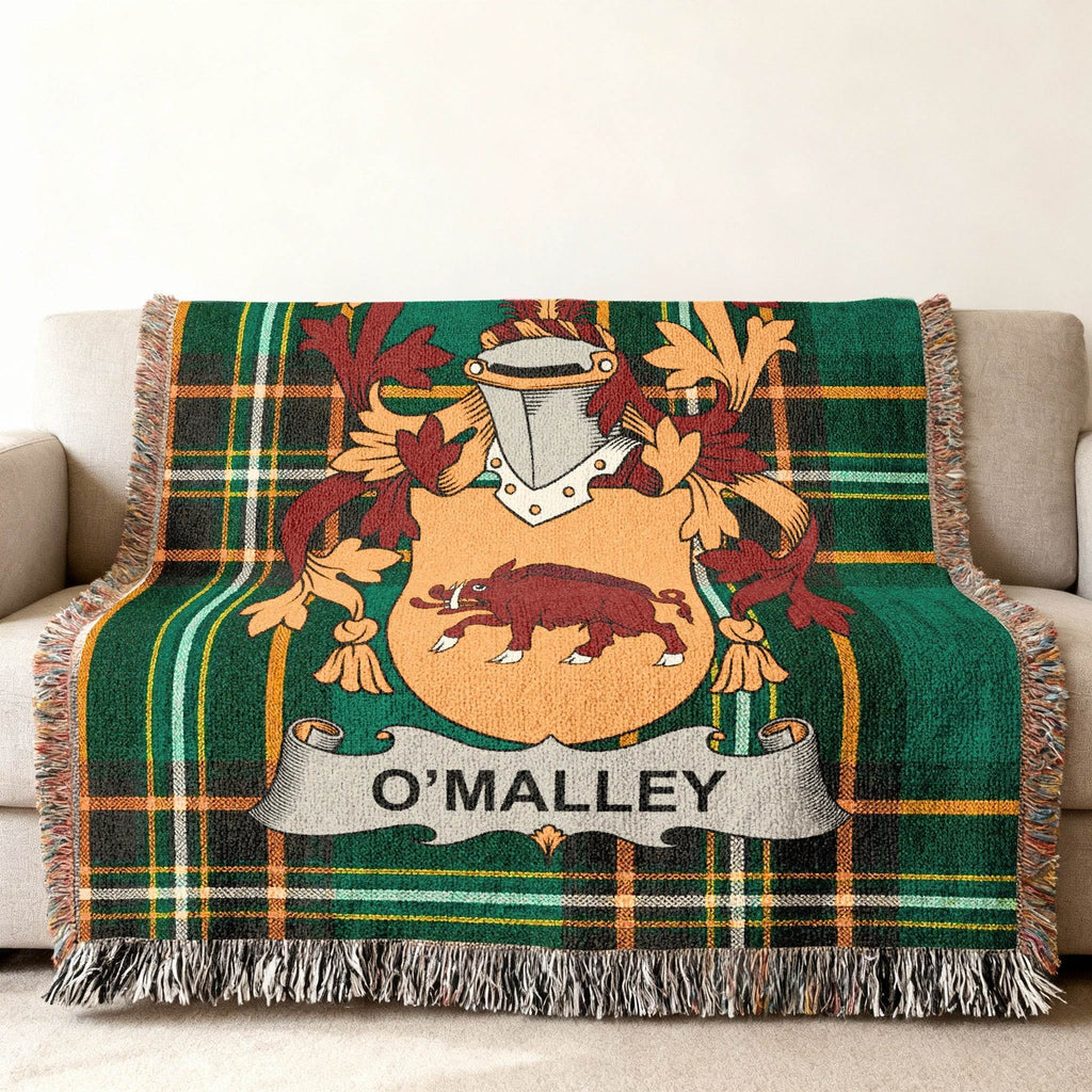 O'Malley family crest on a green tartan woven throw blanket.