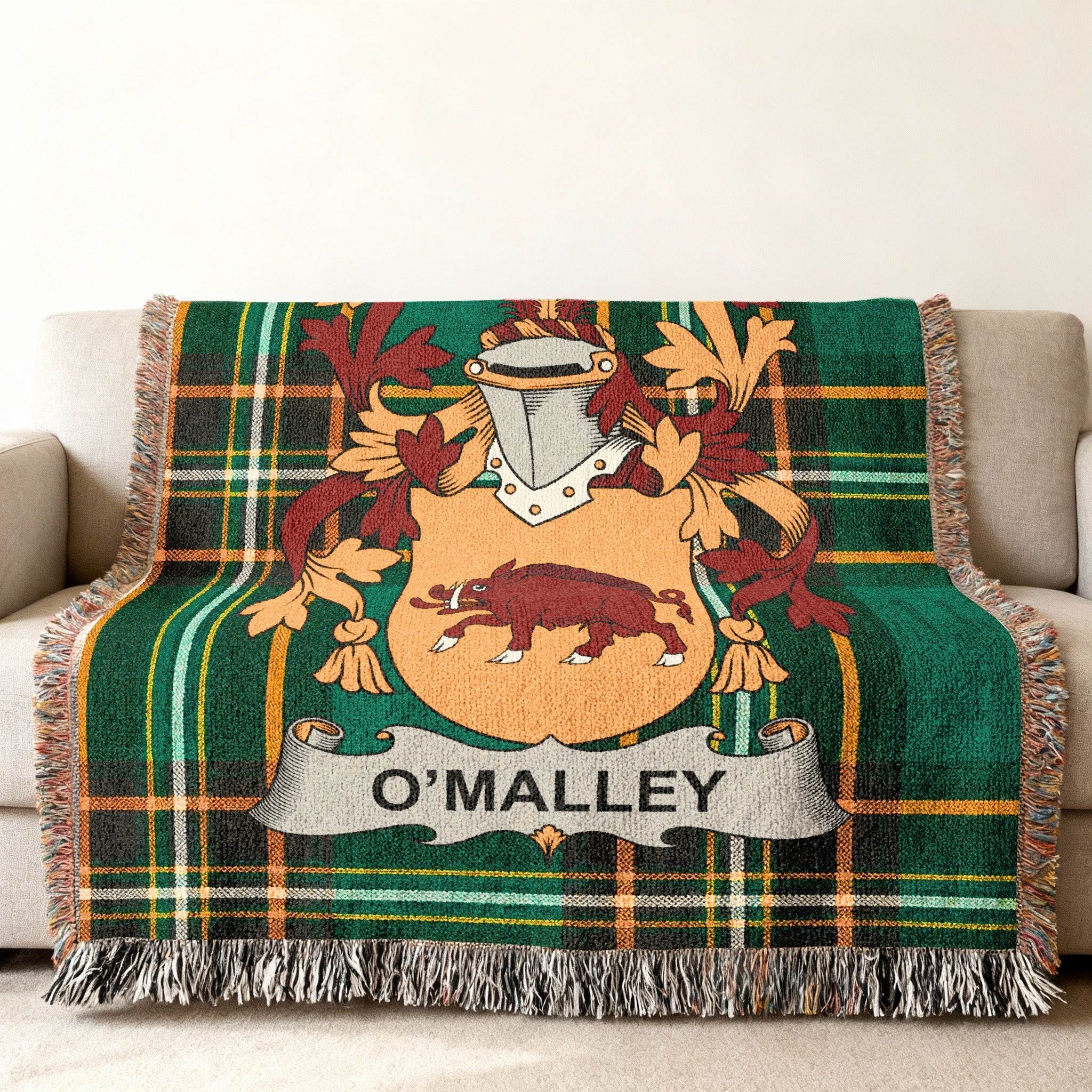 O'Malley family crest on a green tartan woven throw blanket.