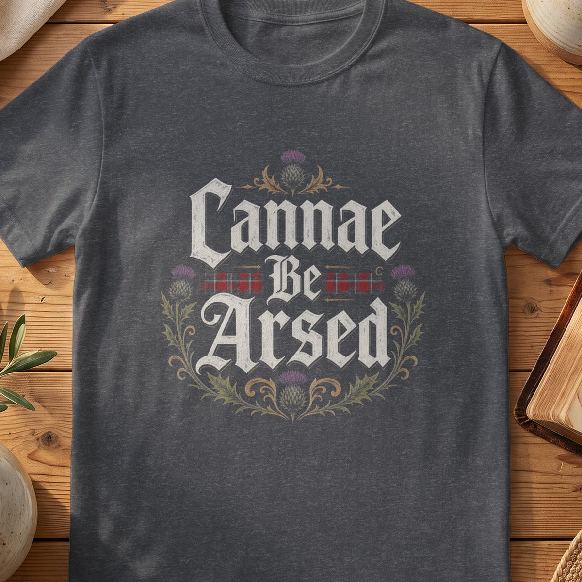 Dark grey Gildan 64000 unisex T-shirt flatlay with Cannae Be Arsed Scottish graphic design