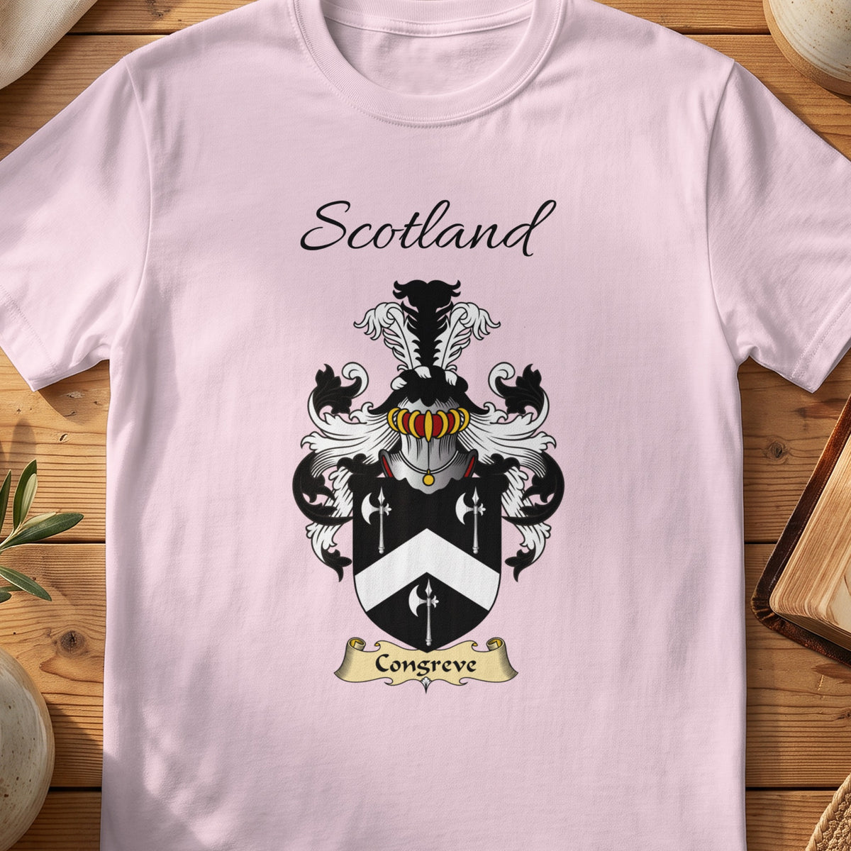 Light Pink Congreve Scottish family shield T-shirt featuring a white chevron and spear-like motifs on black