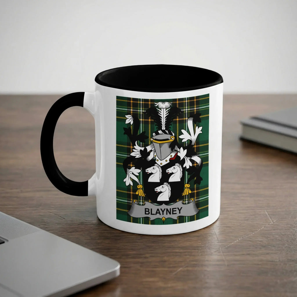 White mug with black rim featuring Blayney family crest on a plaid background.