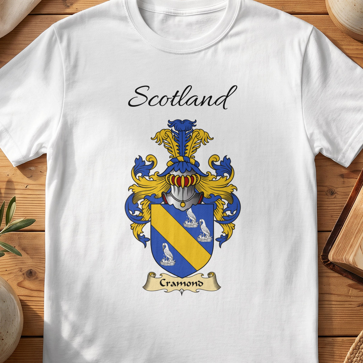 White Cramond Scottish family shield T-shirt featuring a gold diagonal band between pale motifs on blue