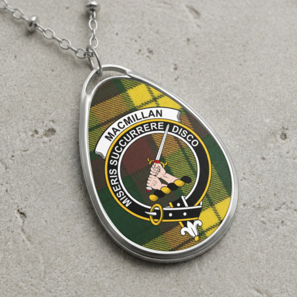 MacMillan clan crest pendant with tartan background and sword.
