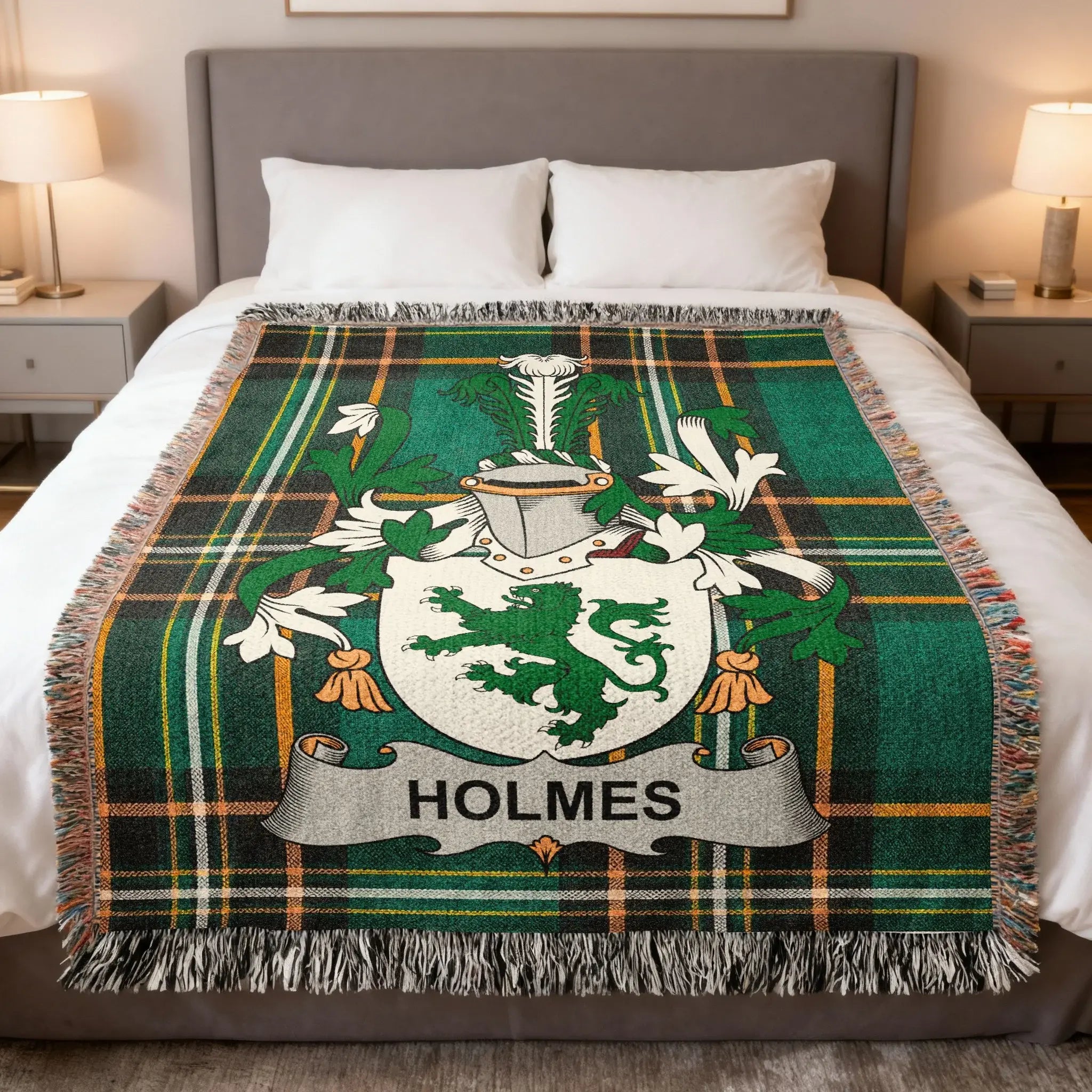 Green and black plaid blanket with Holmes family crest on a bed.