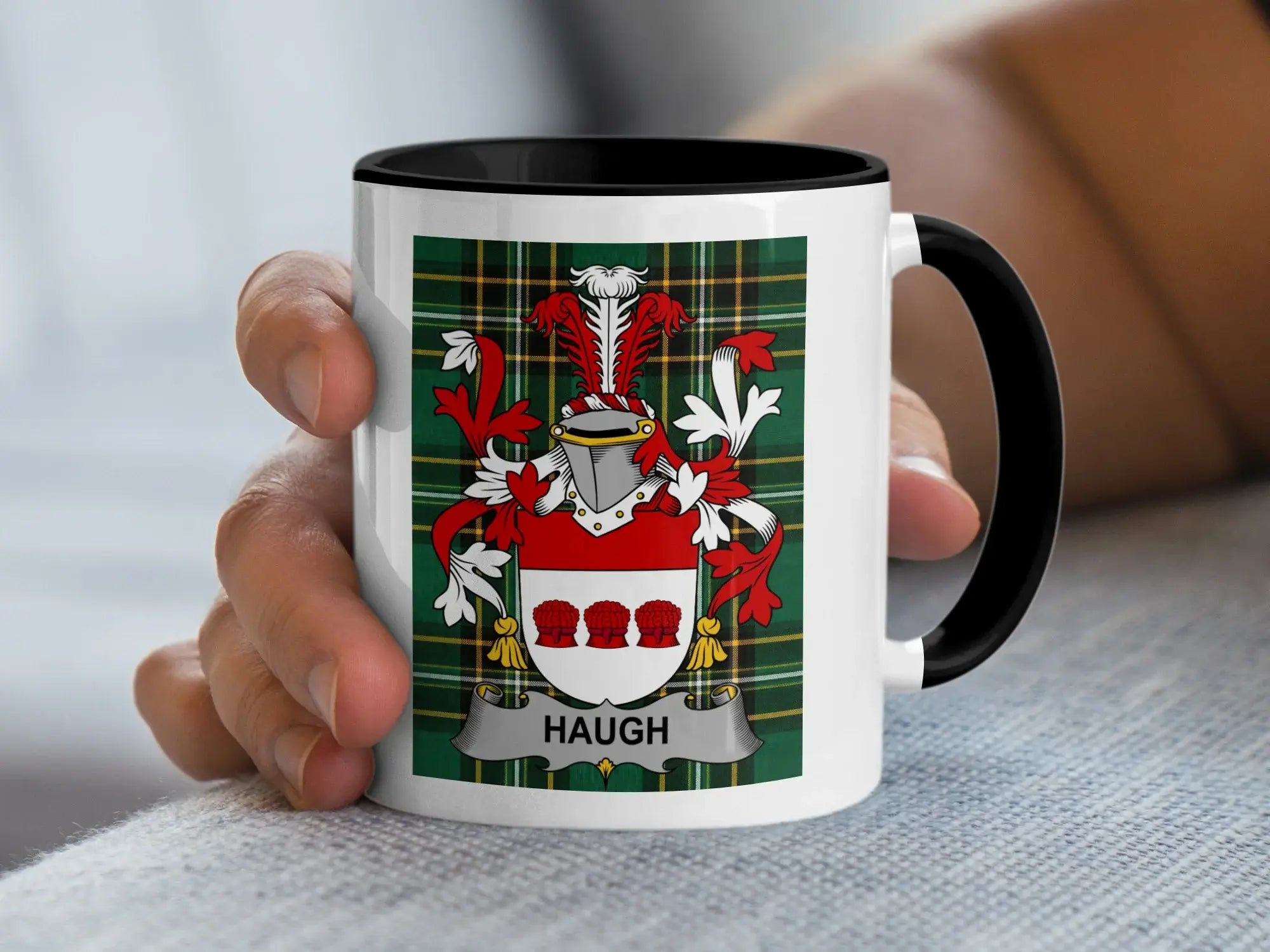 White mug with black rim featuring a family crest with the name "HAUGH".